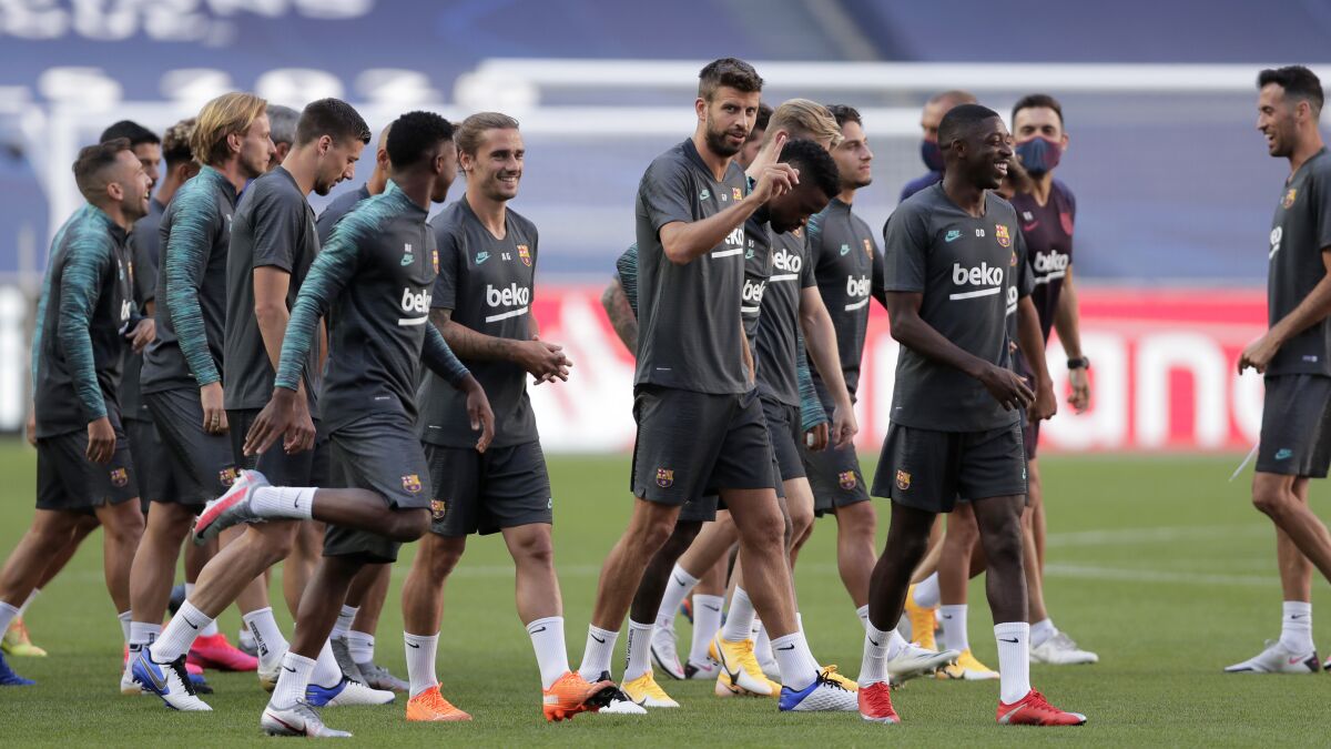 Barcelona's Gerard Pique, center, gestures during a training session at the Luz stadium.