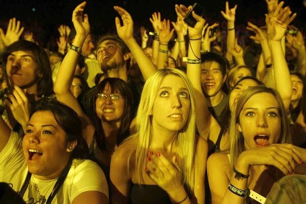 Fans put their hands in the air during KROQ's Almost Acoustic Christmas on Sunday at the Gibson Amphitheatre.
