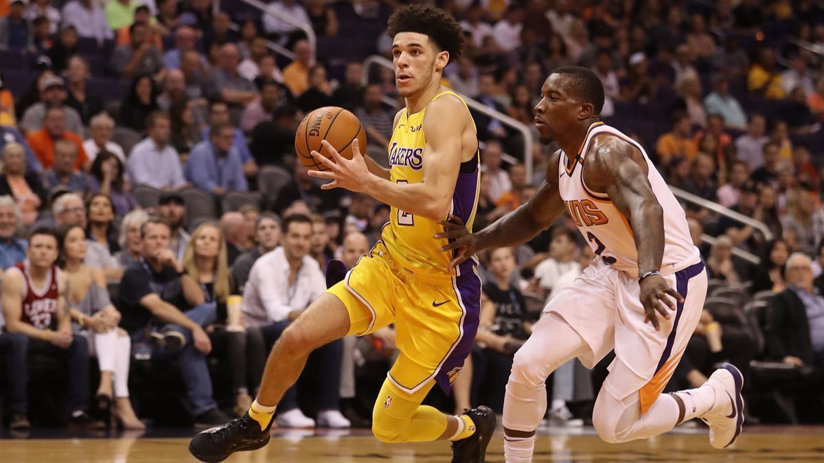 Lakers' Lonzo Ball drives the ball past the Suns' Eric Bledsoe during the first half on Friday's game in Phoenix.