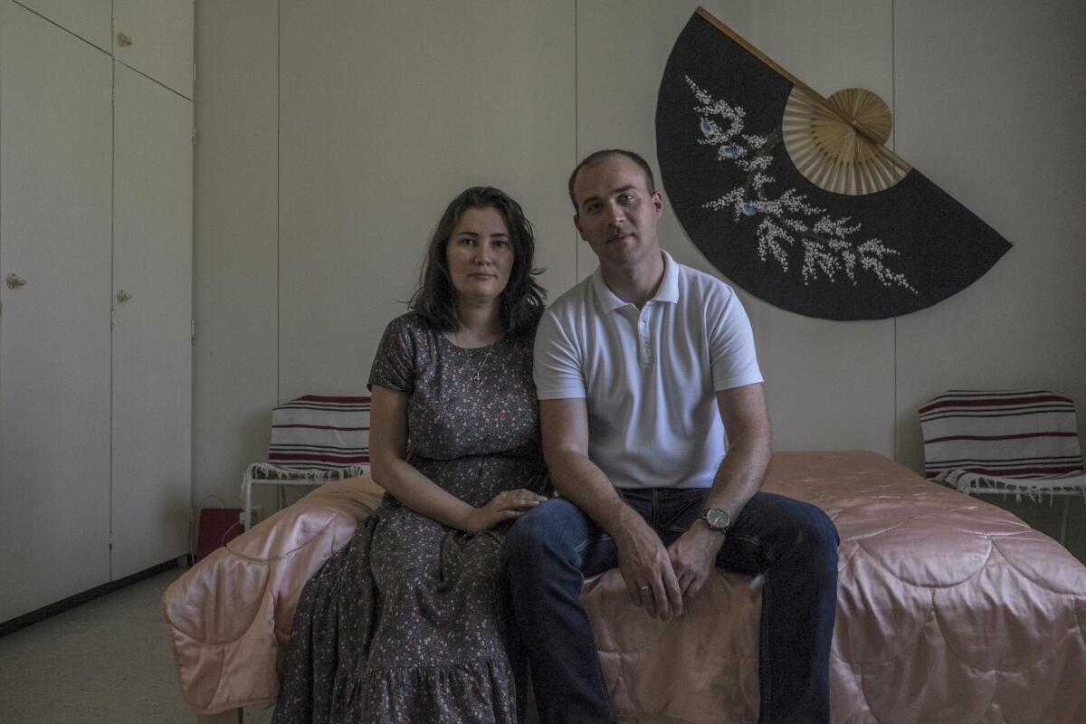 Daniel, 34, and Alina, 35, both from Orenburg, Russia, sit in their room at a refugee center in Konnunsuo, Finland. The couple are Jehovaha's Witnesses seeking asylum in Finland because of religious persecution in their homeland.