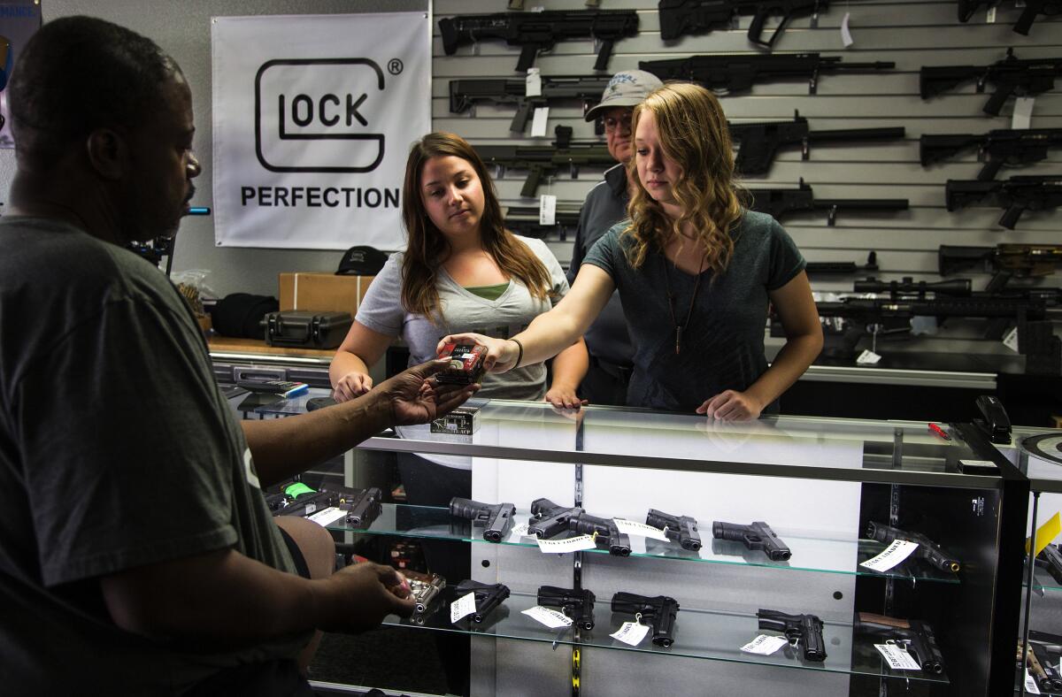 A customer at a gun store counter