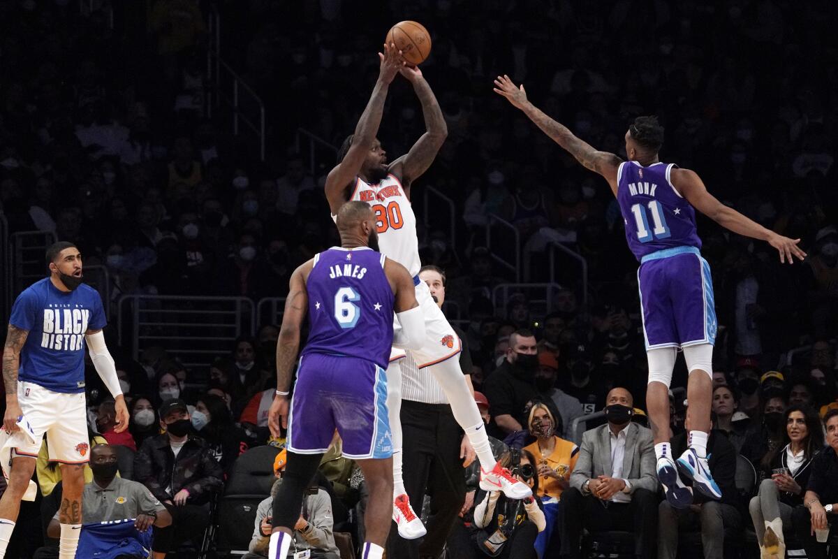 The Knicks' Julius Randle shoots as the Lakers' Malik Monk (11) defends and LeBron James (6) looks on Feb. 5, 2022.