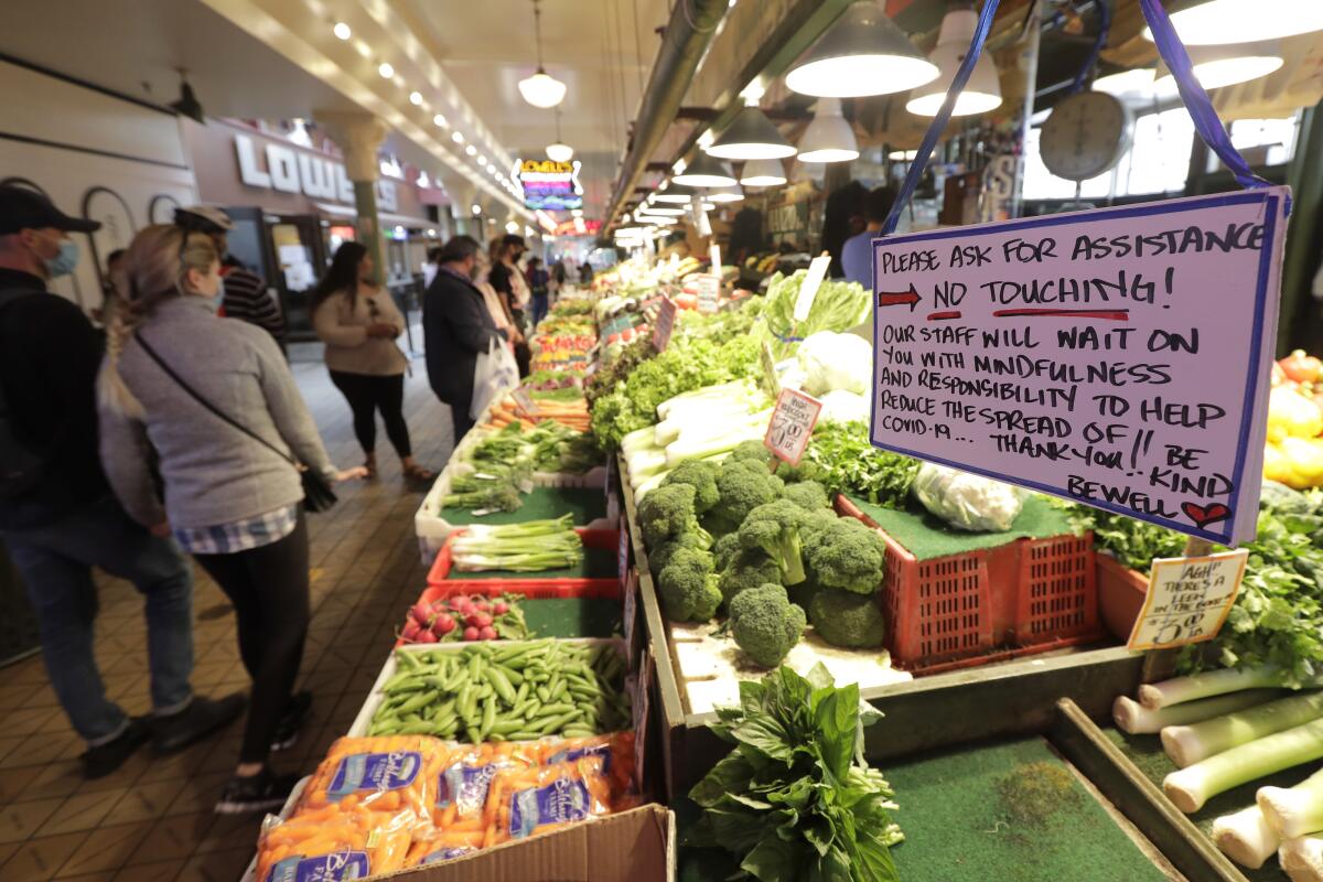 A sign at a produce stand reads "No Touching!" at Pike Place Market in Seattle.