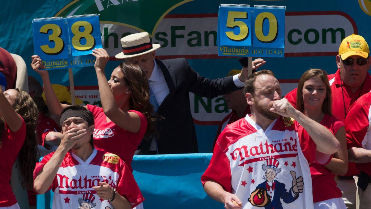 Matt Stonie, left, and Joey Chestnut compete in Nathan's Famous annual Fourth of July hot dog eating contest Monday.