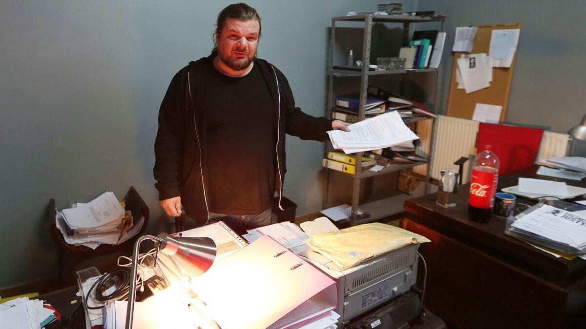 Rafal Gawel, a board member of an organization that monitors racism and xenophobia, stands in his office in Warsaw shortly after it was raided by police Feb. 3.