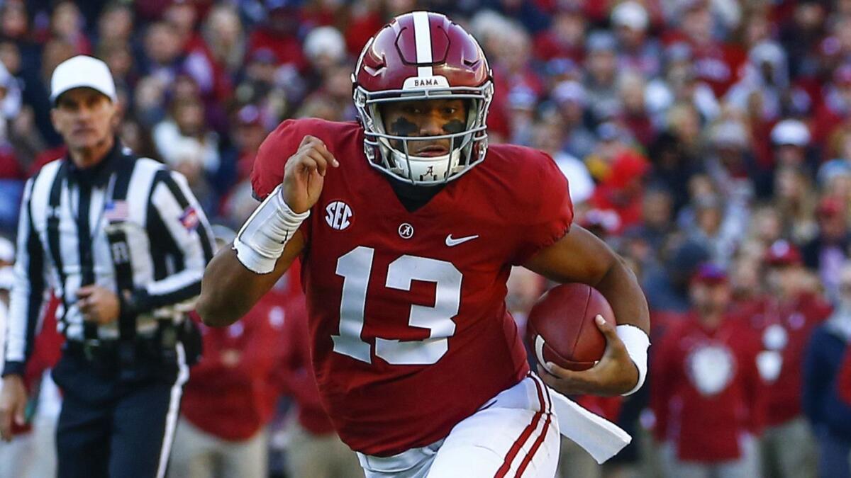 Alabama quarterback Tua Tagovailoa (13) scrambles for yardage during the first half of an NCAA college football game against Mississipi State.