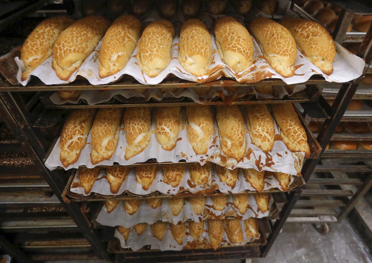 Racks of freshly baked bread at Bread Artisan Bakery in Santa Ana.