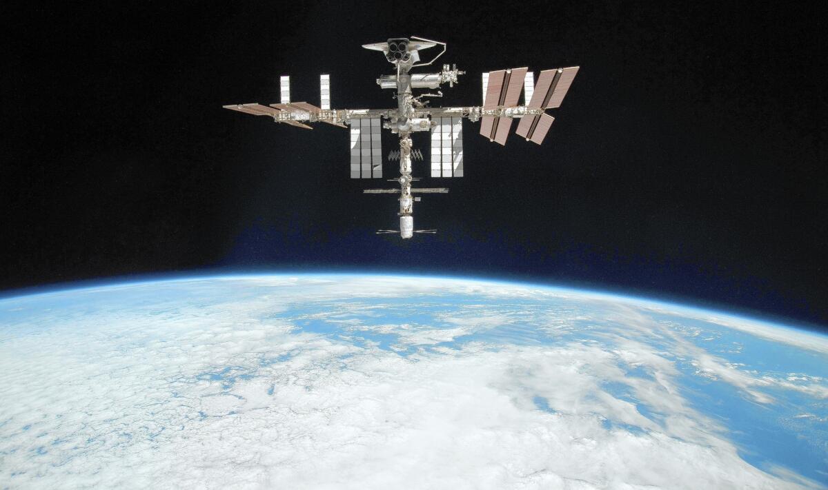 The International Space Station is shown approximately 220 miles above Earth. The Air Force has awarded a $914.7-million contract to Lockheed Martin Corp. to develop a surveillance system that will provide a continuous watch over the cosmic debris orbiting the planet.