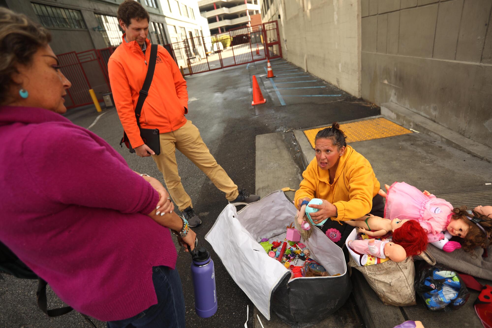 Sally Flores waits to receive medical attention from outreach workers with Substance Use Disorder Integrated Services.