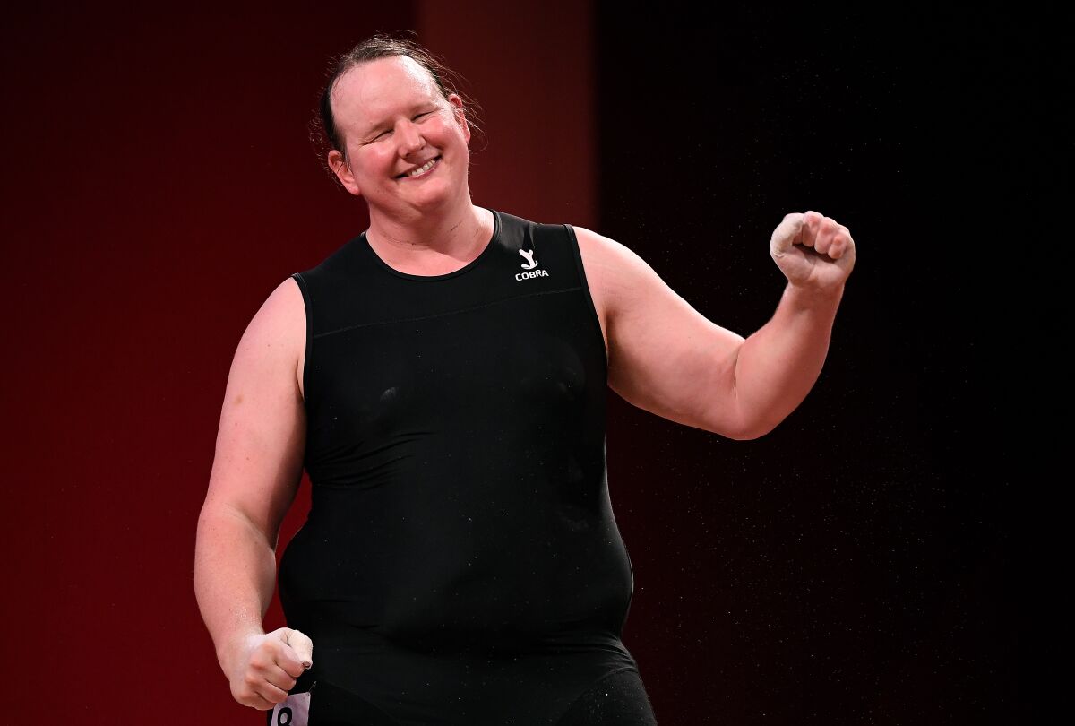 New Zealand's Laurel Hubbard smiles and gestures to the crowd after failing to advance in the plus-192-pound weightlifting.