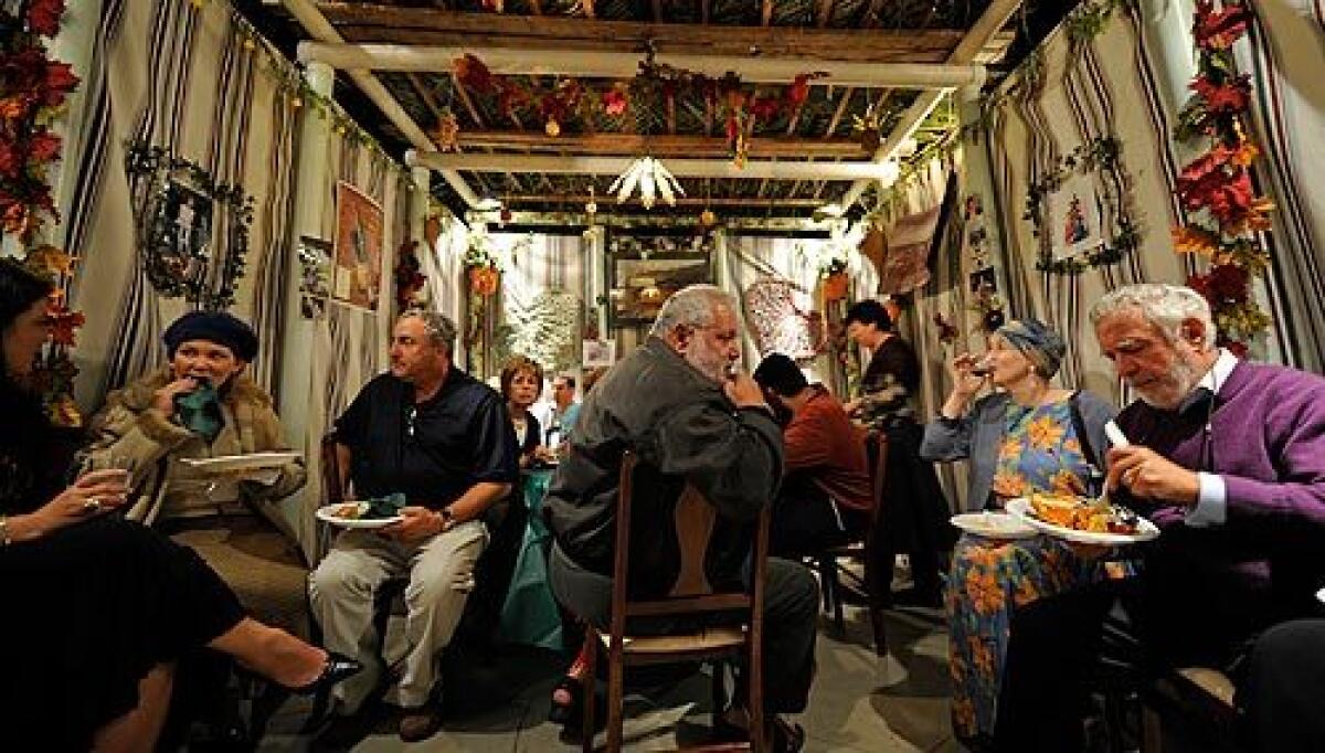 Guests celebrate the Jewish holiday of Sukkot at the Santa Monica home of Alan and Sharon Litman on Thursday. Observers build sukkahs, temporary shelters, and spend much of their time there during the seven-day religious festival. More photos >>>