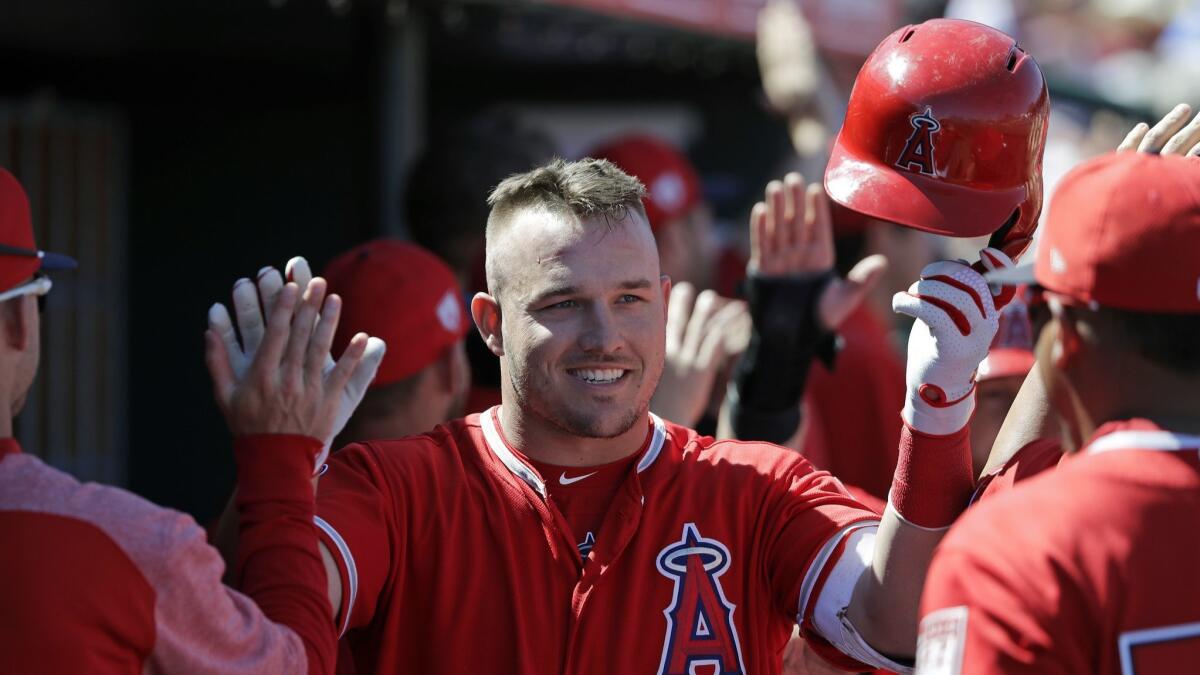 The Angels' Mike Trout is congratulated by teammates on his three-run home run against the Chicago White Sox in the first inning.