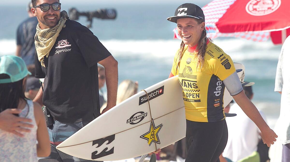 Local Courtney Conlogue comes in smiling after her round two heat of the Van's US Open of Surfing on Tuesday.