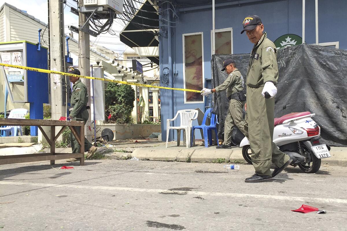 Investigators work at the scene of an explosion in the resort town of Hua Hin, 150 miles south of Bangkok, Thailand on Friday.