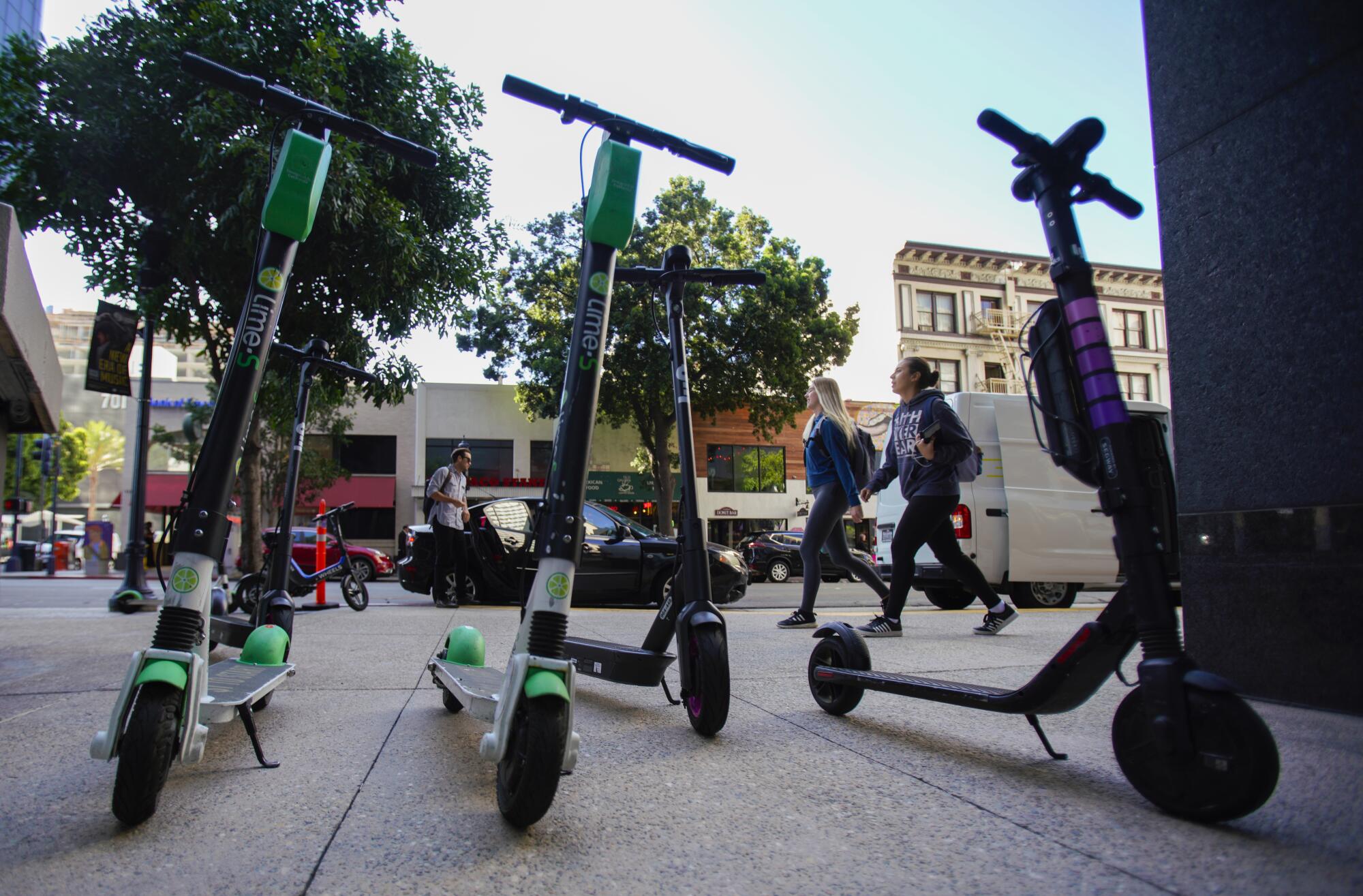 A handful of motorized scooters parked illegally near a high rise office building on B Street and 7th Avenue.