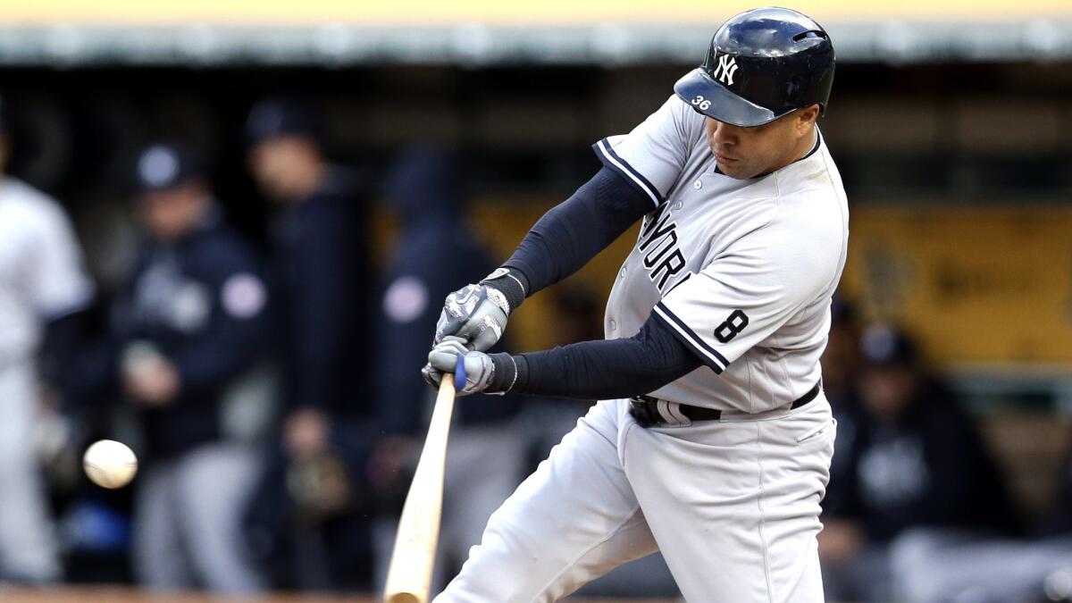 Yankees slugger Carlos Beltran hits a double against the Oakland Athletics during a game May 20.