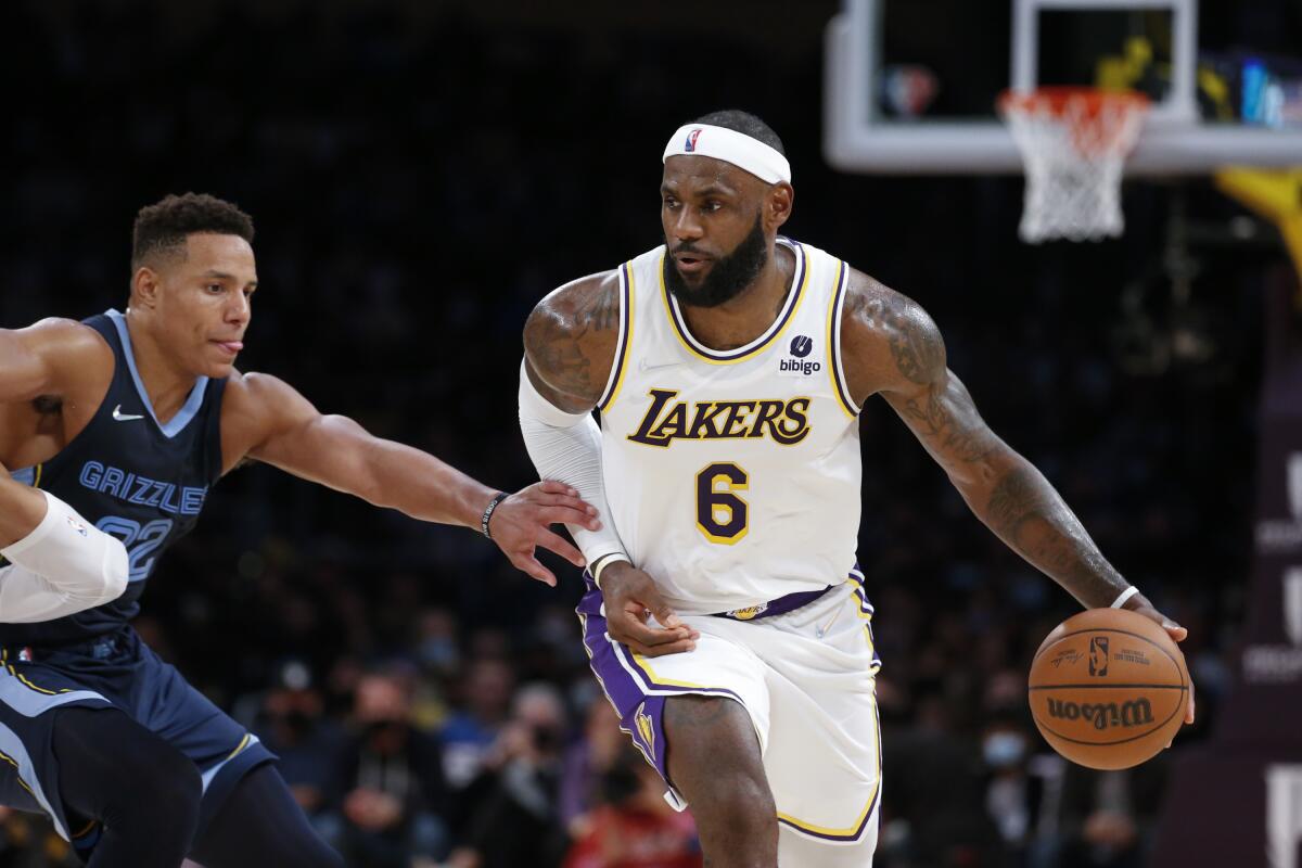 Los Angeles Lakers forward LeBron James drives against Memphis Grizzlies guard Desmond Bane.