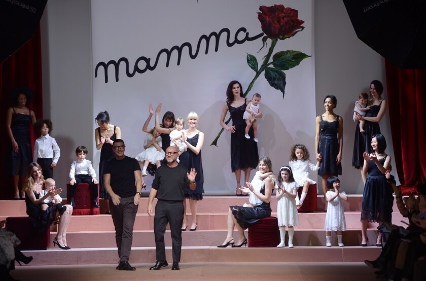 Italian designers Stefano Gabbana, left, and Domenico Dolce greet the audience at the end of their show for Dolce & Gabbana on March 1.