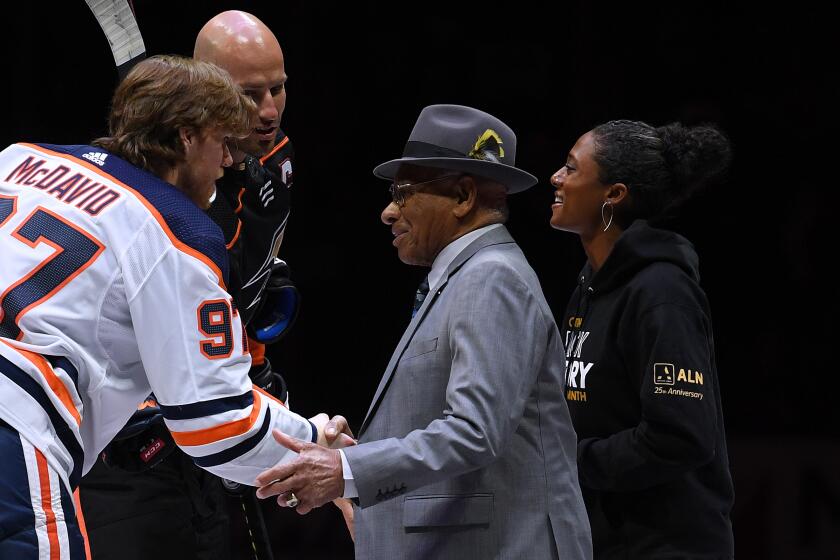 ANAHEIM, CALIFORNIA - FEBRUARY 25: Connor McDavid #97 of the Edmonton Oilers shakes hands with Willie O'Ree along with Blake Bolden and Ryan Getzlaf #15 of the Anaheim Ducks before the game in celebration of Black Histiory Month at Honda Center on February 25, 2020 in Anaheim, California. (Photo by Harry How/Getty Images) ** OUTS - ELSENT, FPG, CM - OUTS * NM, PH, VA if sourced by CT, LA or MoD **