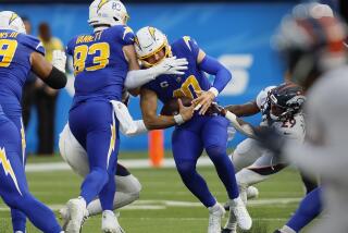 Chargers quarterback Justin Herbert is sacked by Broncos outside linebacker Nik Bonitto.
