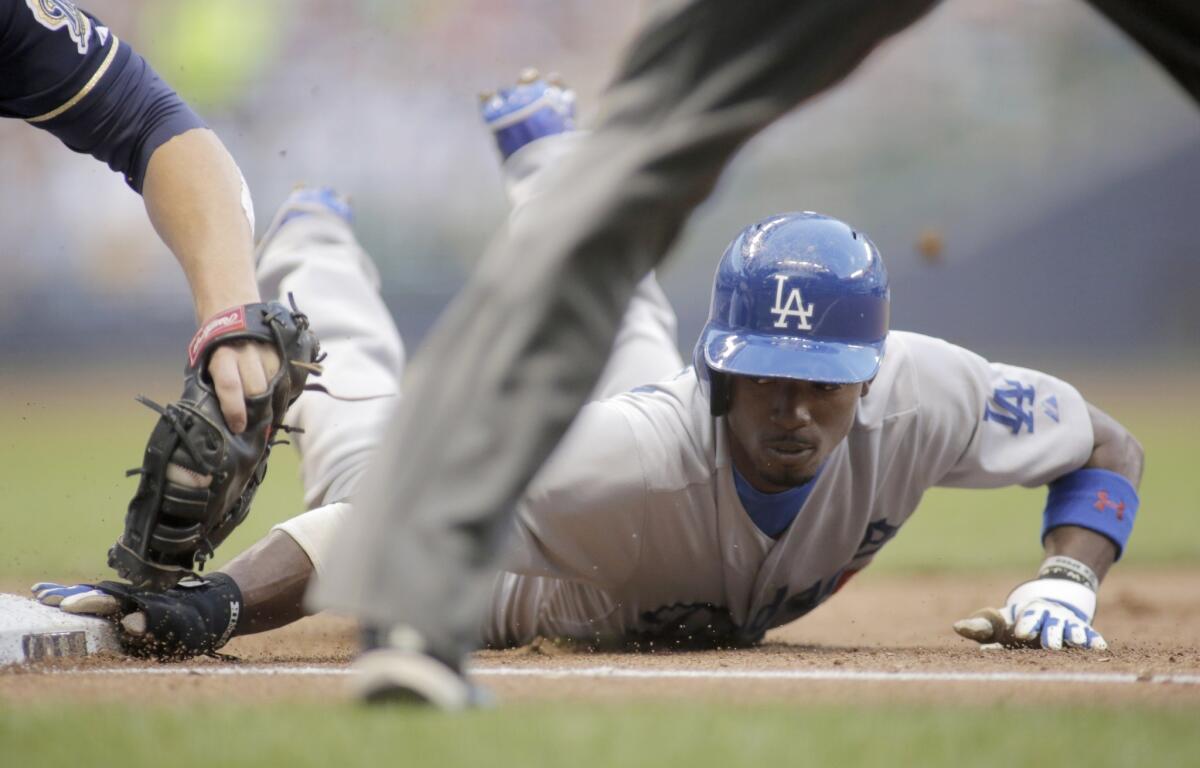 Dee Gordon is called safe at first base during the sixth inning of the Dodgers' 4-1 loss Saturday to the Brewers at Miller Park. Gordon was caught attempting to steal second base later in the inning.