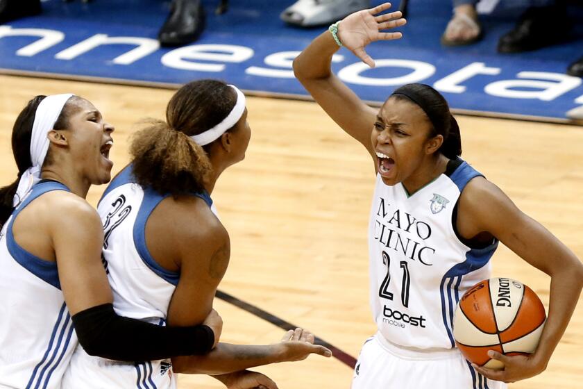 Minnesota Lynx players (from left) Maya Moore, Rebekkah Brunson and Renee Montgomery celebrate during their Game 5 victory over the Indiana Fever on Wednesday night.