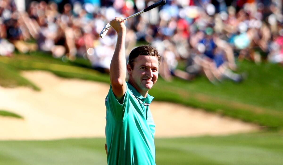 Jimmy Walker celebrates after making his putt on the 18th hole to win the Valero Texas Open on Sunday.