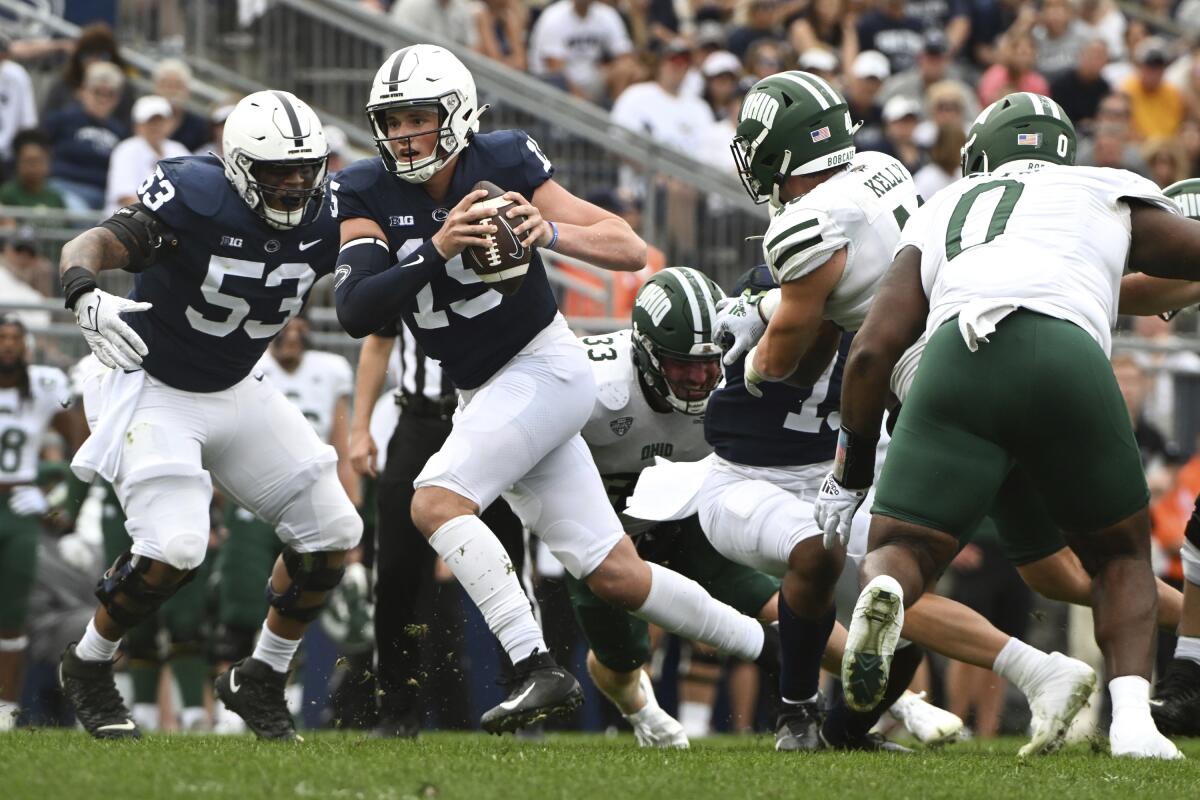 Penn State quarterback Drew Allar (15) scrambles away from Ohio linebacker Kyle Kelly (48) during the second half of an NCAA college football game , Saturday, Sept. 10, 2022, in State College, Pa. (AP Photo/Barry Reeger)