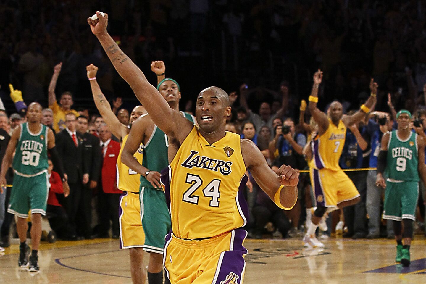 Kobe Bryant celebrates among other players on the court after the Lakers beat the Boston Celtics in the 2010 NBA Finals.