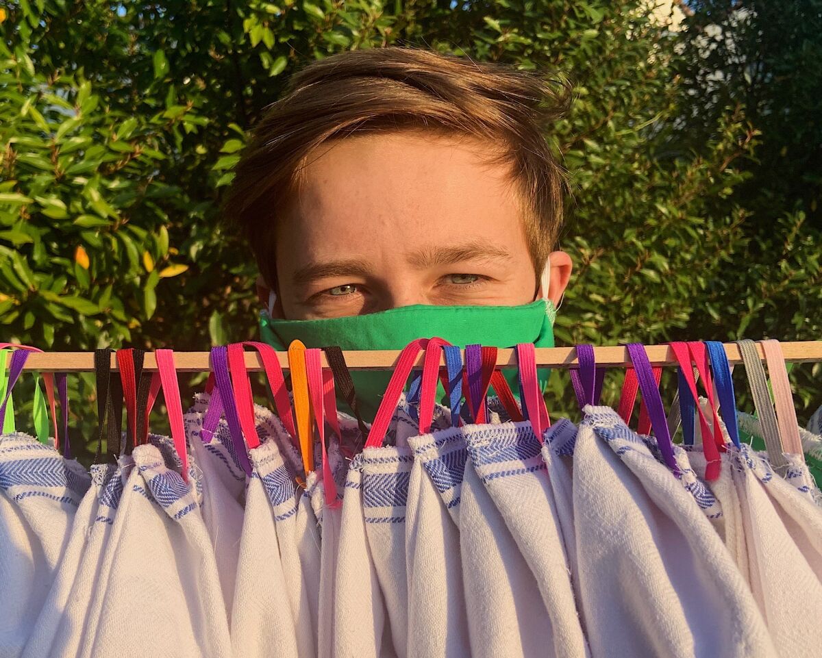 Carson Doan shows off some finished masks.