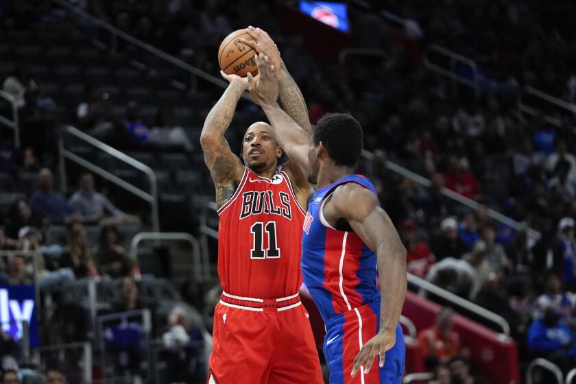 Chicago Bulls forward DeMar DeRozan (11) shoots on Detroit Pistons center Jalen Duren (0) in the first half of an NBA basketball game in Detroit, Thursday, April 11, 2024. (AP Photo/Paul Sancya)