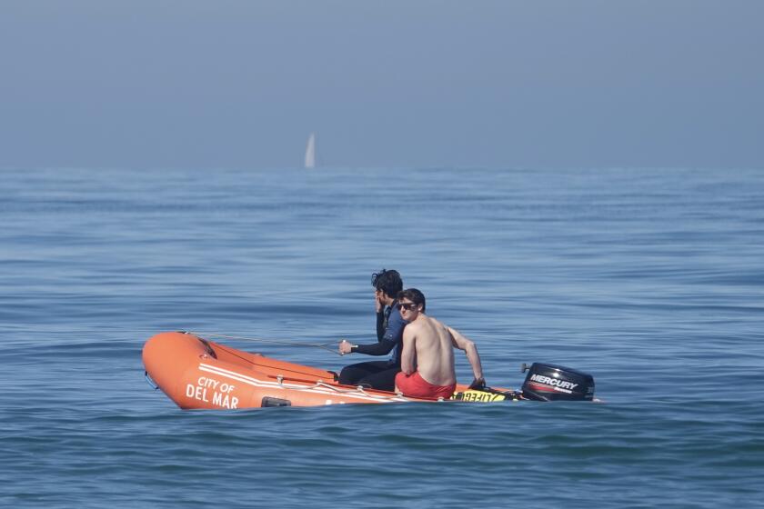Del Mar lifeguards patrol in waters that have been unusually cold lately.