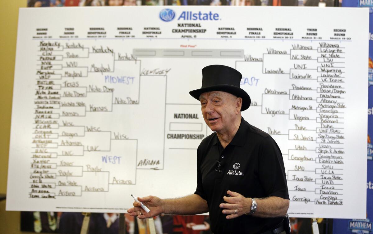 Basketball analyst Dick Vitale explains his tournament picks Tuesday in Indianapolis. Vital is going head-to-head with groundhog Punxsutawney Phil in a bracket-picking contest for the NCAA Tournament.