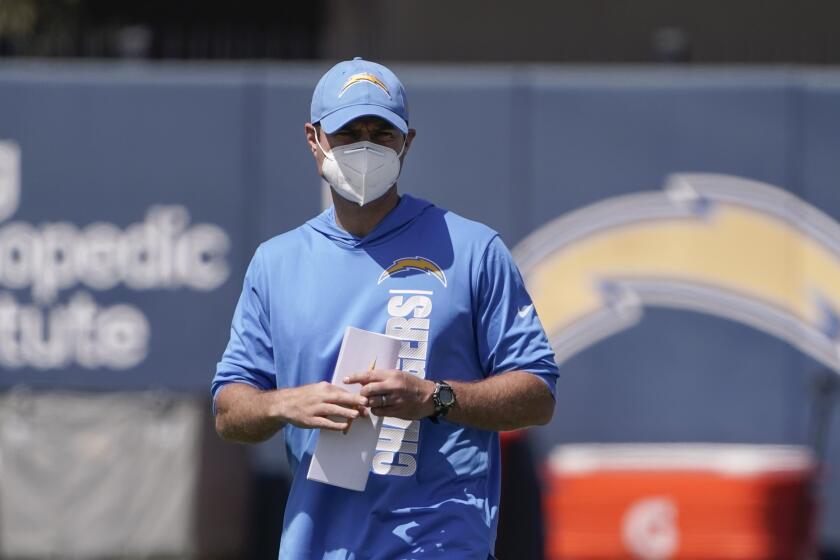 Los Angeles Chargers head coach Brandon Staley watches as his players warm up during an NFL football rookie minicamp in Costa Mesa, Calif., Friday, May 14, 2021. (AP Photo/Jae C. Hong)