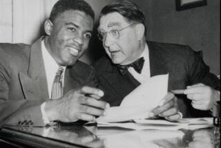 ADVANCE FOR WEEKEND MARCH 22 –23 FILE––Brooklyn Dodgers' Jackie Robinson, left, and Dodgers president Branch Rickey look over Robinson's contract in the Dodgers Brooklyn offices January 24, 1950. It has been 50 years since Robinson broke the color barrier and changed baseball forever. (AP Photo/file)