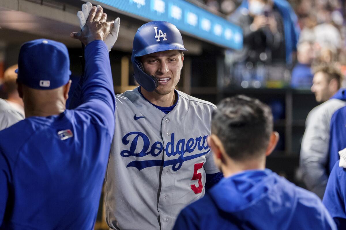 The Dodgers' Corey Seager (5) celebrates in the dugout after hitting a solo home run during the ninth inning Sept. 4, 2021.