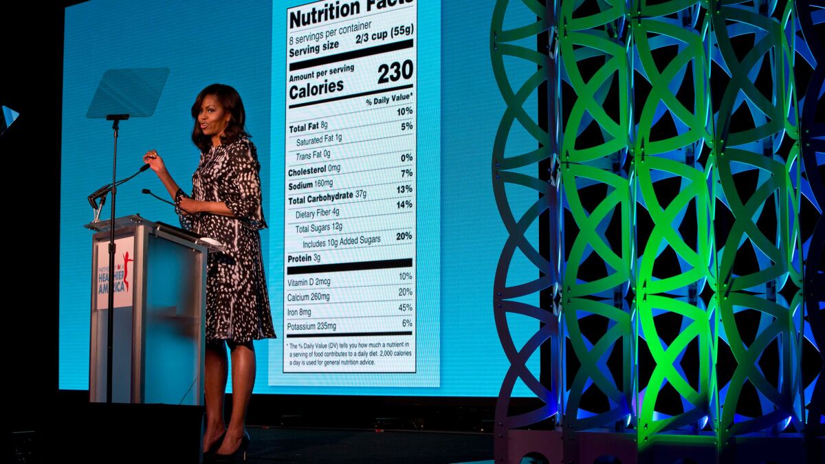 First Lady Michelle Obama unveils a makeover for food nutrition labels, with calories listed in bigger type and a new line for added sugars, in Washington, D.C. in May.