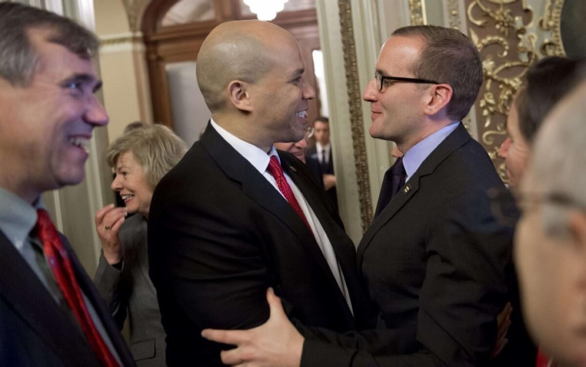 U.S. Sen. Cory Booker (D-N.J.), left, embraces Chad Griffin of the Human Rights Campaign after the Senate passed the Employment Non-Discrimination Act in 2013.