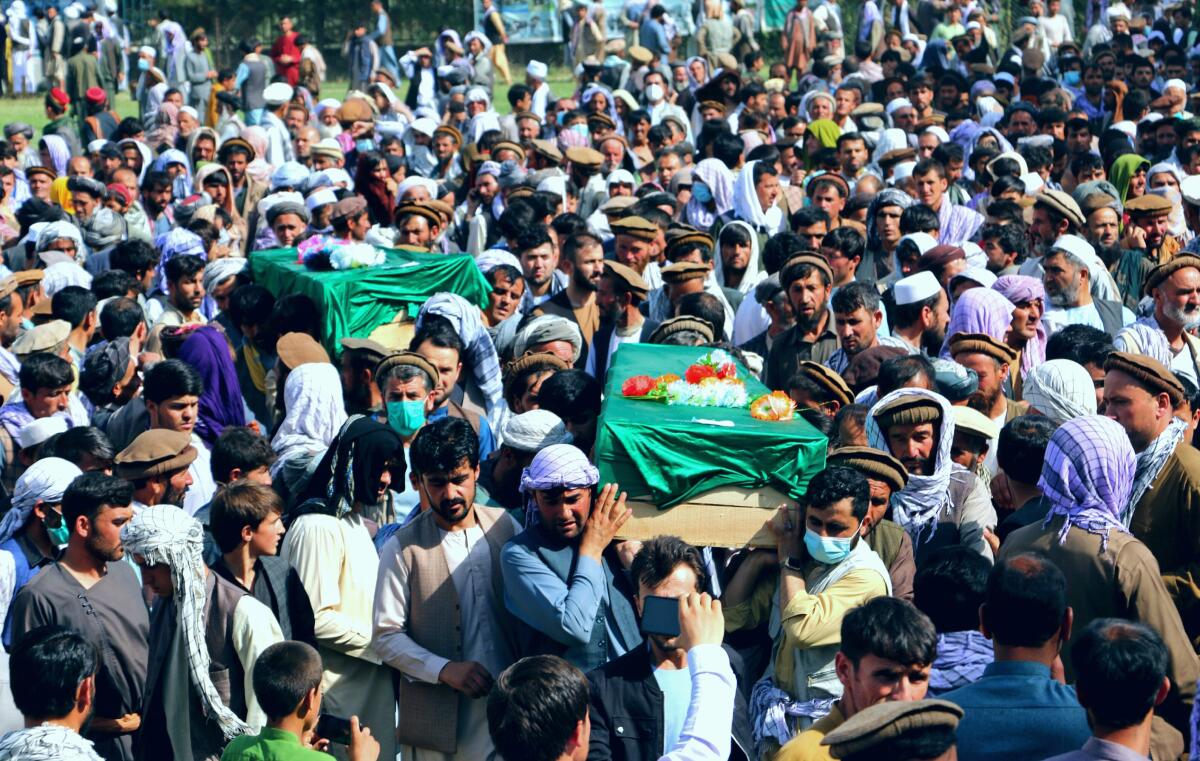 Afghans carry the body of civilians killed during fighting between the Taliban and Security forces, during their funeral, in Badakhshan province, northern Afghanistan, Sunday, July 4, 2021. Officials said Sunday that the Taliban’s march through northern Afghanistan has gained momentum with the capture of several districts from fleeing Afghan forces. They said that several hundred of them fled across the border into Tajikistan.(AP Photo/Nazim Qasmy)