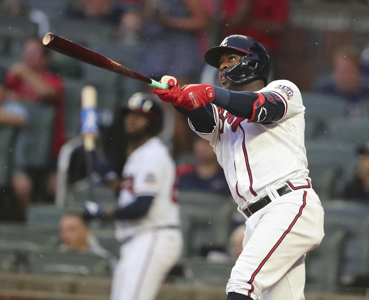 Atlanta Braves' Guillermo Heredia watches his two-run home run against the Cincinnati Reds during the second inning of a baseball game Wednesday, Aug. 11, 2021, in Atlanta. (Curtis Compton/Atlanta Journal-Constitution via AP)