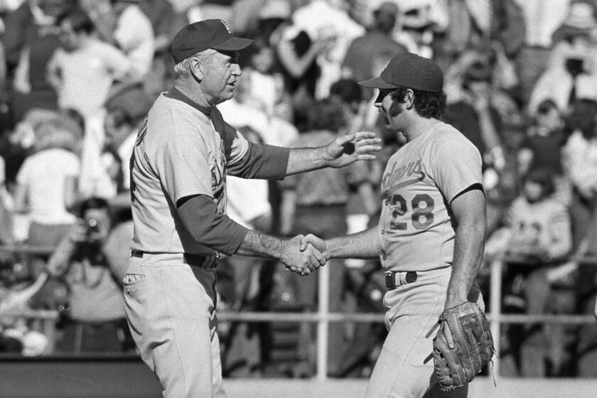 FILE - In this Oct. 6, 1974, file photo, Los Angeles Dodgers manager Walt Alston, left, congratulates relief pitcher Mike Marshall after the Dodgers defeated the Pittsburgh Pirates 5-2 in Game 2 of the NL Championship Series in Pittsburgh. Marshall, who became the first reliever to win the Cy Young Award while pitching for the Dodgers and eight other major league teams in both leagues, has died. Marshall, 78, died Monday night, May 31, 2021, in Zephyrhills, Fla., according to the Dodgers, who spoke Tuesday to his daughter, Rebekah. She said he had been in hospice care, but did not give a cause of death. (AP Photo, File)