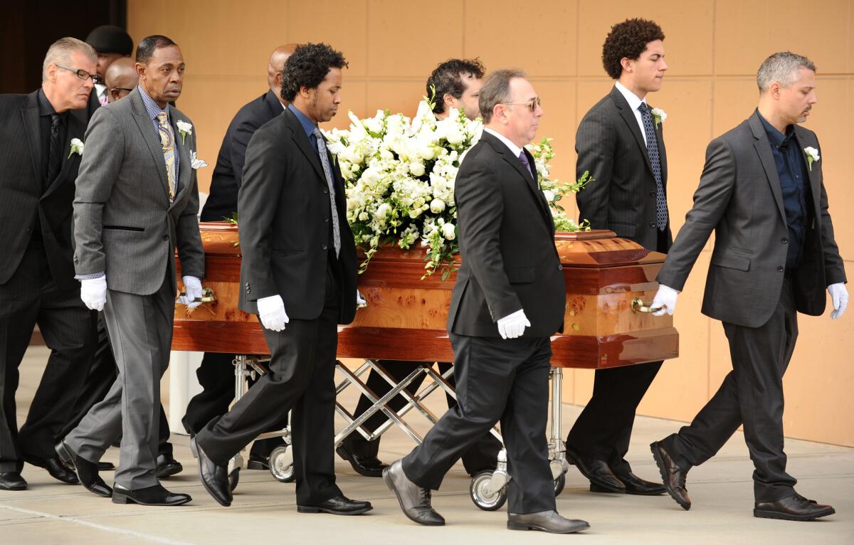 The casket of singer Natalie Cole is carried out of the West Angeles Church of God in Christ during funeral services Monday.