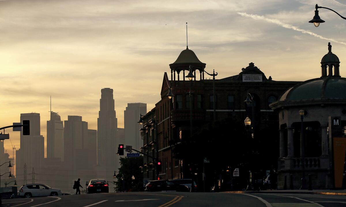 A historic building in Boyle Heights at sunset with the downtown L.A. skyline in the background