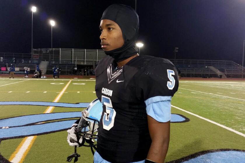 Carson wide receiver Jabari Minix gets set to warm up before the playoff game against Crenshaw on Friday night.