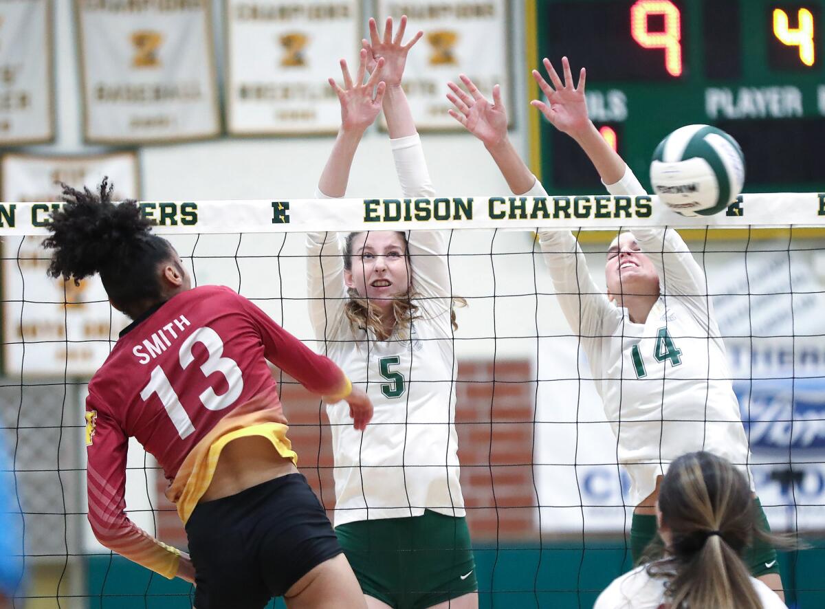Edison's Megan Fitzmorris (5) and Ashley Finch team up for a block on Long Beach Wilson's Allanah Smith (13) on Wednesday.