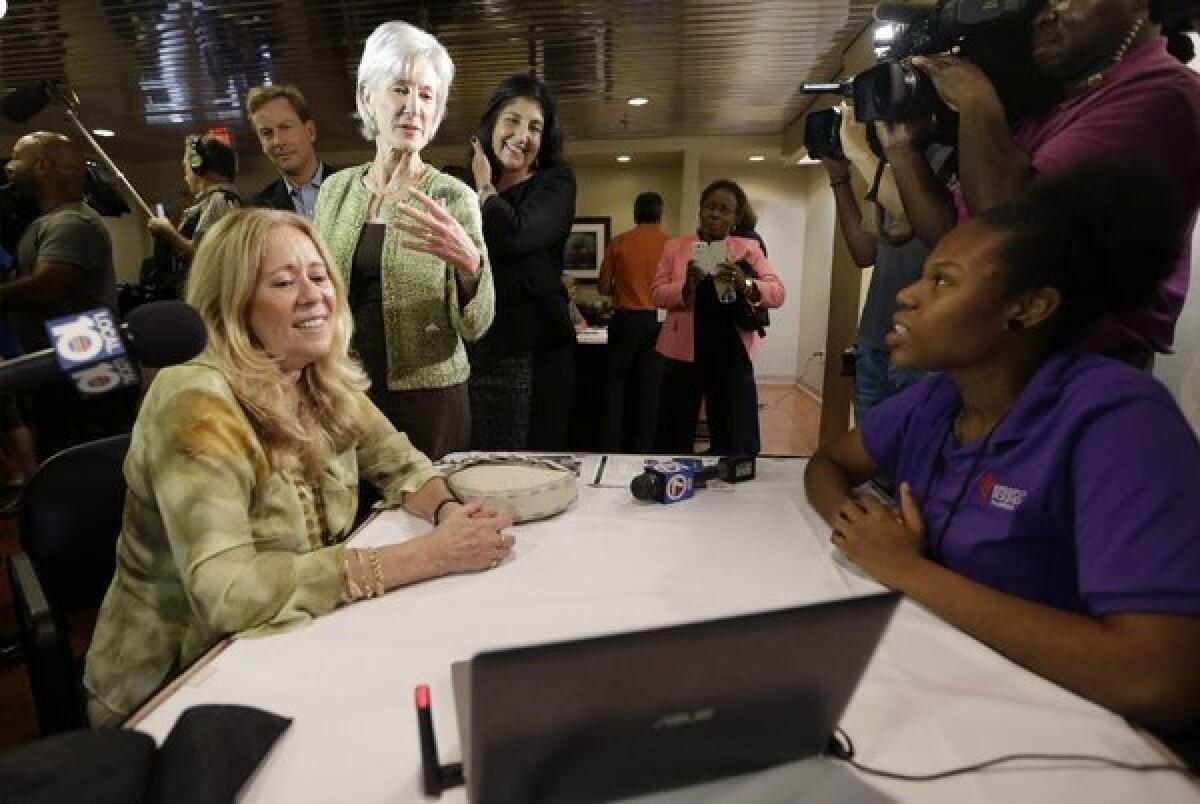 Still looking for a solution: HHS Secretary Kathleen Sebelius (standing, left) at an Obamacare enrollment event in Florida.