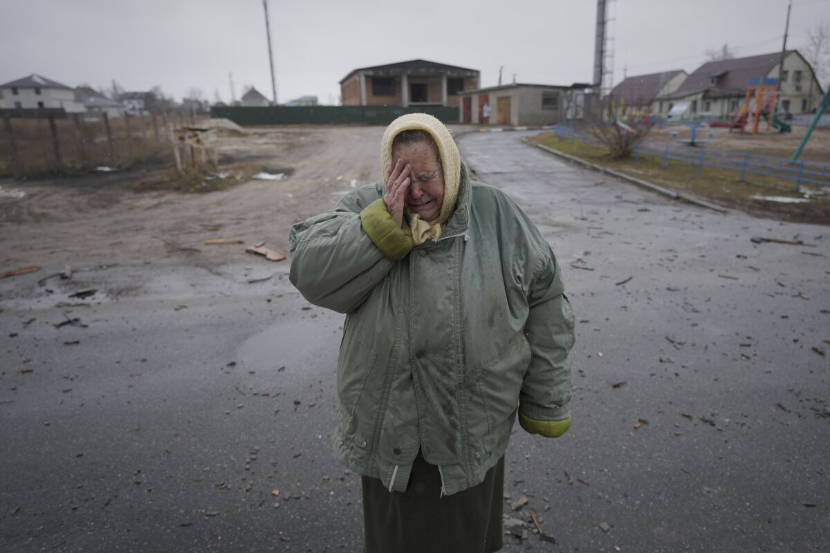 A woman cries outside houses damaged by a Russian airstrike, according to locals, in Gorenka, outside the capital Kyiv, Ukraine, Wednesday, March 2, 2022. Russia renewed its assault on Ukraine's second-largest city in a pounding that lit up the skyline with balls of fire over populated areas, even as both sides said they were ready to resume talks aimed at stopping the new devastating war in Europe. (AP Photo/Vadim Ghirda)