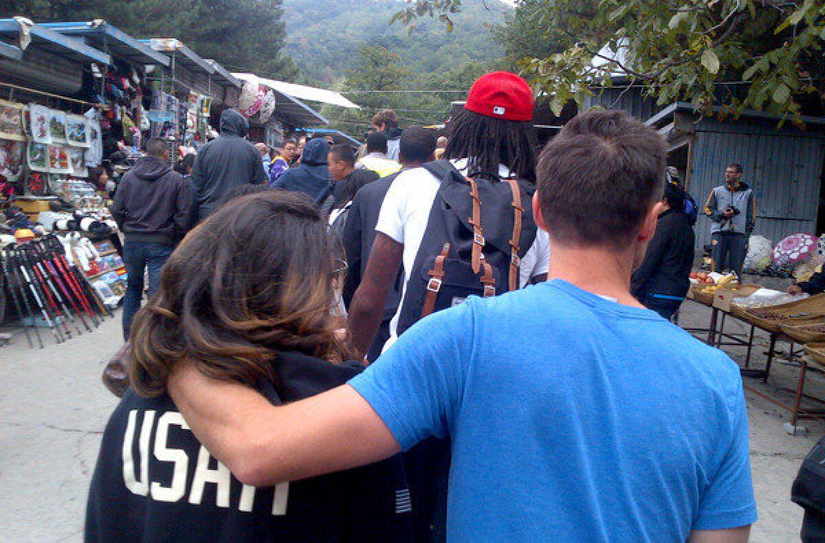 Steve Nash and his girlfriend follow Jordan Hill and other Lakers teammates through a market on the way to the Great Wall of China on Sunday.