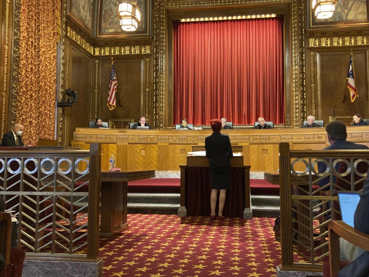 A lawyer stands before justices in a courtroom
