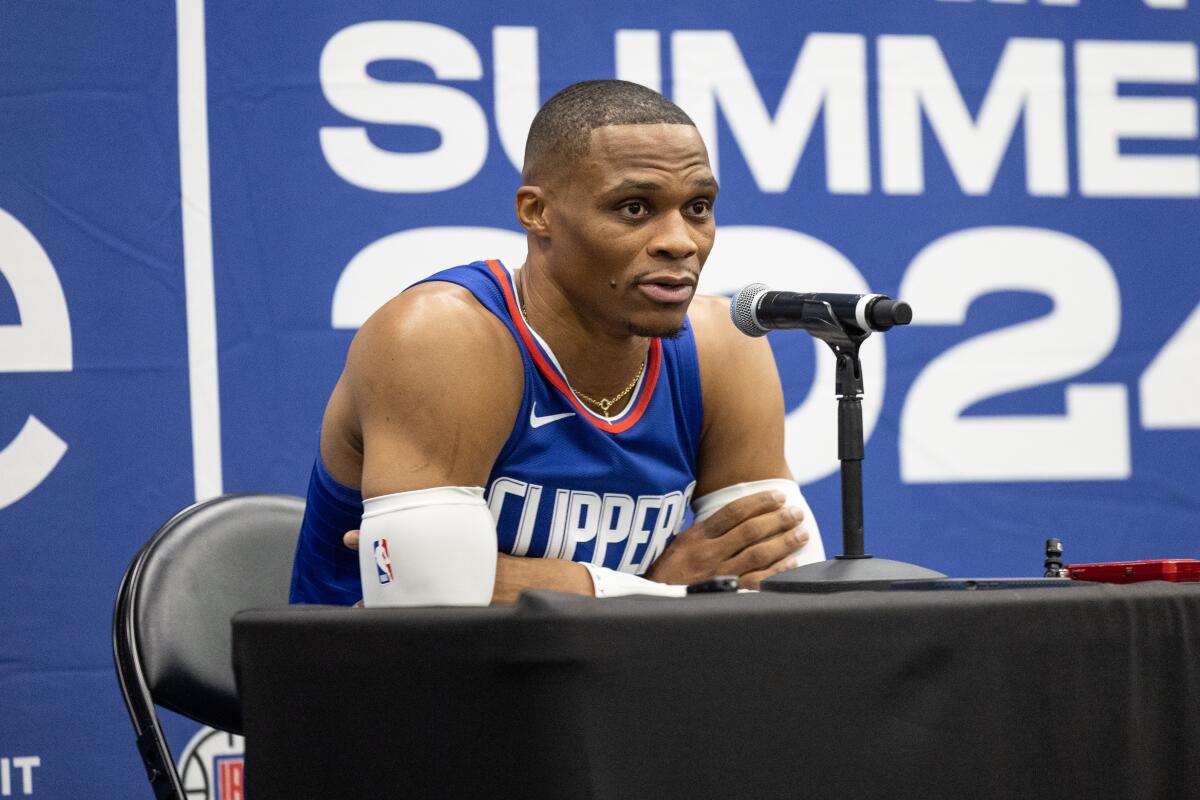 Russell Westbrook speaks from behind a table during team media day on Monday.